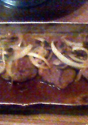 A picture of smothered steaks w/ mushroom and onions.