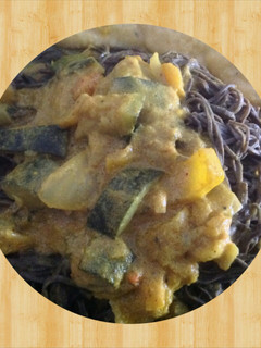 A picture of Veggie Curry over Black Bean Spaghetti.