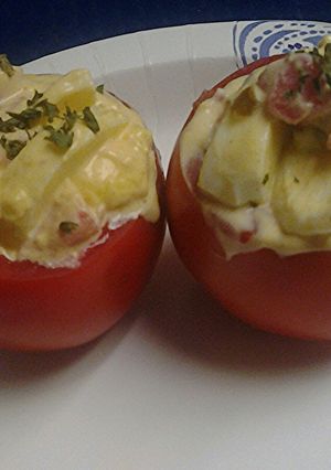 A picture of Spicy Egg salad stuffed tomato.