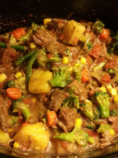 A picture of Beef & Veggies over rice.