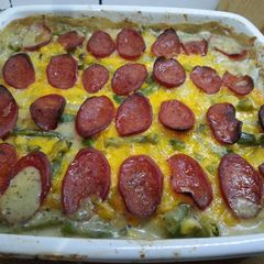 A picture of Green bean and potato casserole with pepperoni and cheese.