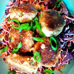 A picture of Thai-inspired pork meatballs with sesame-soy shredded vegetables.