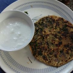 A picture of Methi parantha with curd.