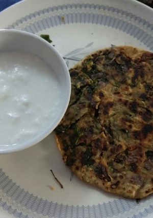 A picture of Methi parantha with curd.