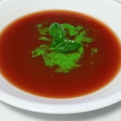 A picture of RAW TOMATO SOUP with BASIL OIL.
