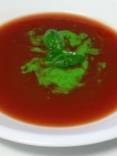 A picture of RAW TOMATO SOUP with BASIL OIL.