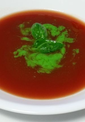 A picture of RAW TOMATO SOUP with BASIL OIL.