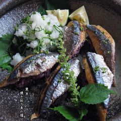 A picture of Grilled Pacific Saury Sushi with Black Rice.