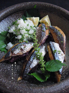 A picture of Grilled Pacific Saury Sushi with Black Rice.