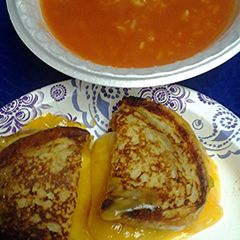 A picture of grilled cheese with tomato soup three options.