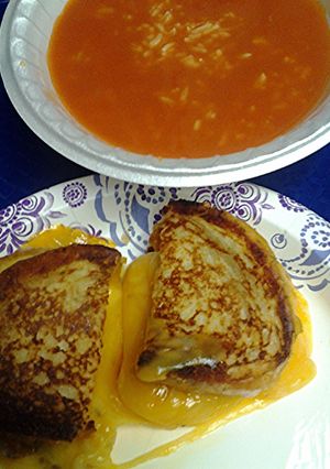 A picture of grilled cheese with tomato soup three options.