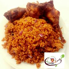 A picture of Fried chicken with jollof rice.
