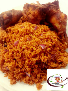A picture of Fried chicken with jollof rice.