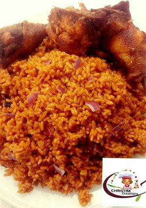 A picture of Fried chicken with jollof rice.