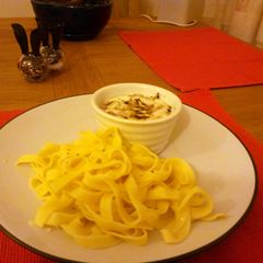 A picture of creamy eggs and fresh pasta.