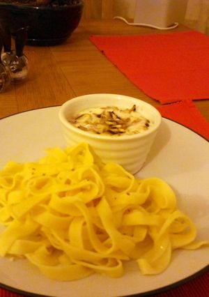 A picture of creamy eggs and fresh pasta.