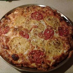 A picture of White Pizza with Garlic and Tomatoes.