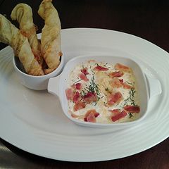A picture of Shirred Eggs with Bacon and Cheese.