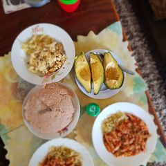 A picture of Dry and wet eggs with cabbages,avocadoes and ugali.