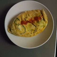 A picture of Baked eggs with vegetables.