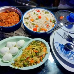 A picture of Veggie rice, chicken stew and stir fried cabbage sauce.
