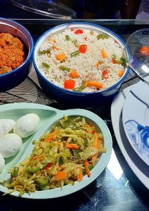 A picture of Veggie rice, chicken stew and stir fried cabbage sauce.
