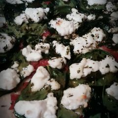 A picture of Spinach and goat cheese pizza.