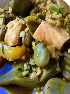 Una foto de Arroz caldoso con alcachofas, habas y salmón