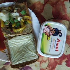 A picture of Open cheese, capsicum corn sandwich.