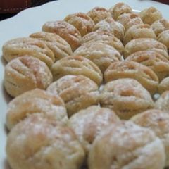 A picture of Walnut stuffed cookies - maamoul bi joz.
