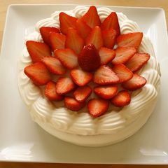 A picture of A Patissier's Cake Decorated With Lots of Strawberries.