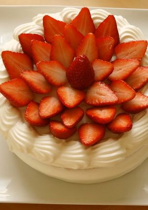 A picture of A Patissier's Cake Decorated With Lots of Strawberries.