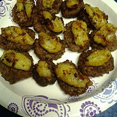 A picture of Fried Bananas Atop Sausage.