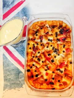 A picture of Leftover bread pudding with creamy custard sauce.