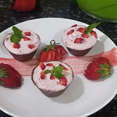 A picture of Chocolate strawberry mousse in chocolate cups.