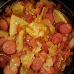 A picture of Cabbage and smoked sausage.
