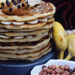 A picture of Chick pea and banana pancakes with peanut butter spread.