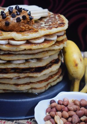 A picture of Chick pea and banana pancakes with peanut butter spread.