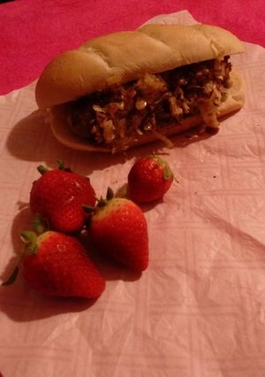 A picture of Polish Fresh Sausage and Sauerkraut on a sub roll.