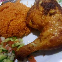 A picture of Garlic chicken leg /red rice /salad.