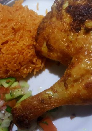 A picture of Garlic chicken leg /red rice /salad.