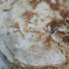 A picture of Noodles with fried egg.