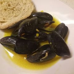 Mussels in a white wine & saffron sauce with oregano bruschette A picture of Mussels in a white wine & saffron sauce with oregano bruschette.