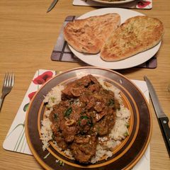 A picture of Punjabi Lamb curry served with rice.