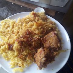 A picture of Tumeric rice And chicken stew.