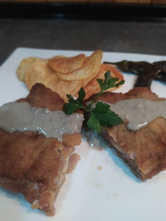 Una foto de Cachopo de jamón y queso con salsa de cabrales y patatas paprika