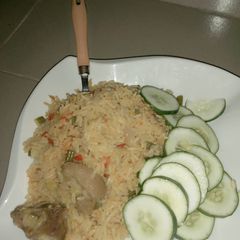 Jollof rice and cucumber A picture of Jollof rice and cucumber.
