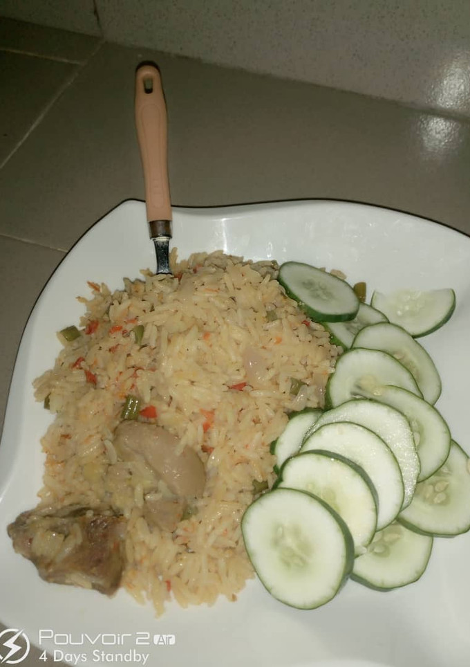 A picture of Jollof rice and cucumber.