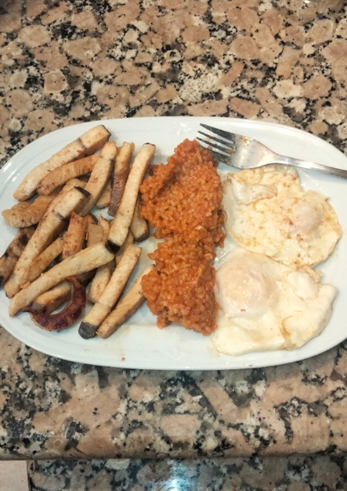 Una foto de Pez espada al limón con arroz rojo y huevos