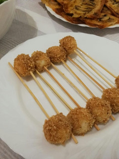 Una foto de Pinchos de huevos de codorniz empanados en piñones